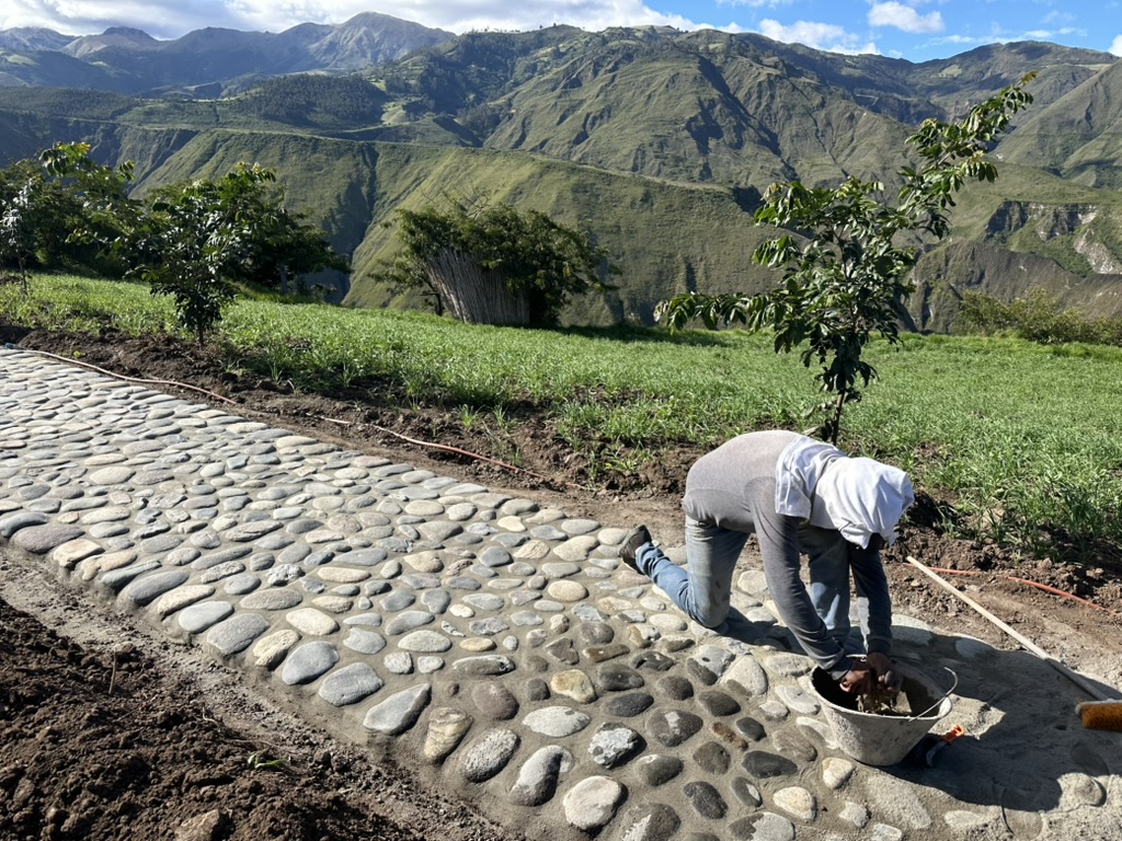 Hand-laying a cobblestone path across the farm