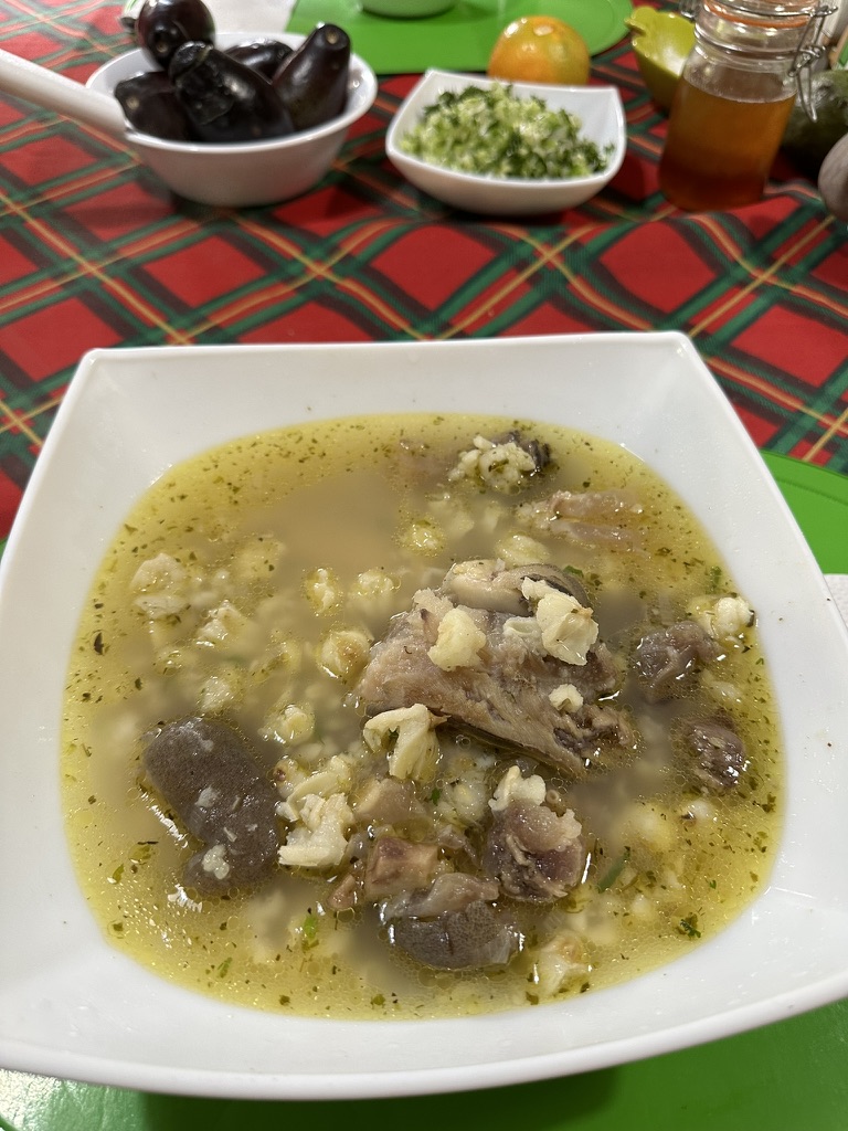 A bowl of highland caldo with hominy and potatoes