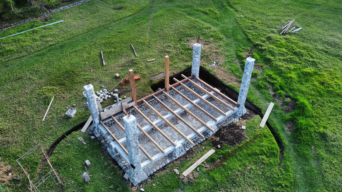 Aerial view of stone columns and wooden floor joists for the studio