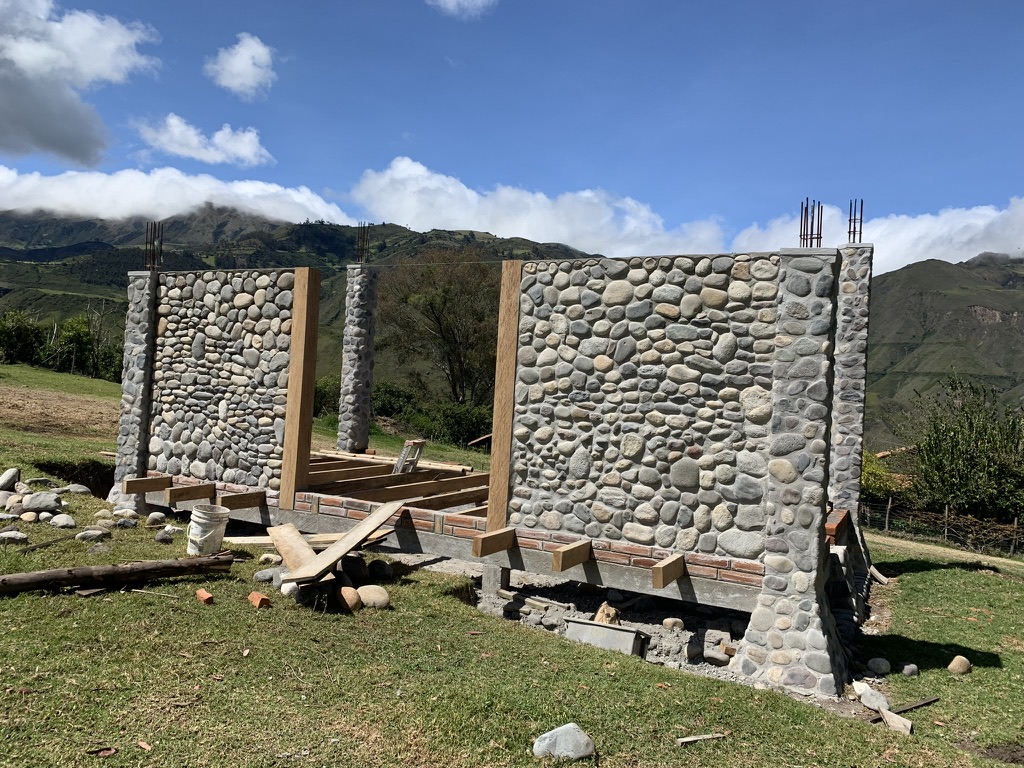 Stone walls and columns with heavy clouds rolling over the ridge