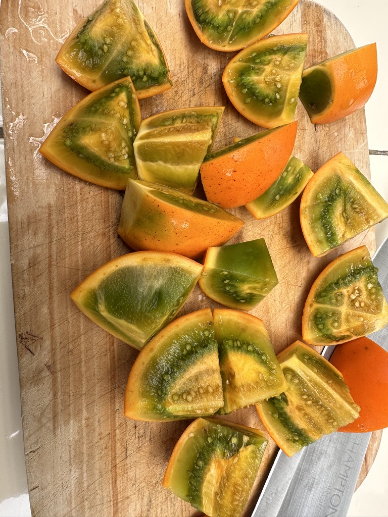 Sliced naranjilla on a wooden board